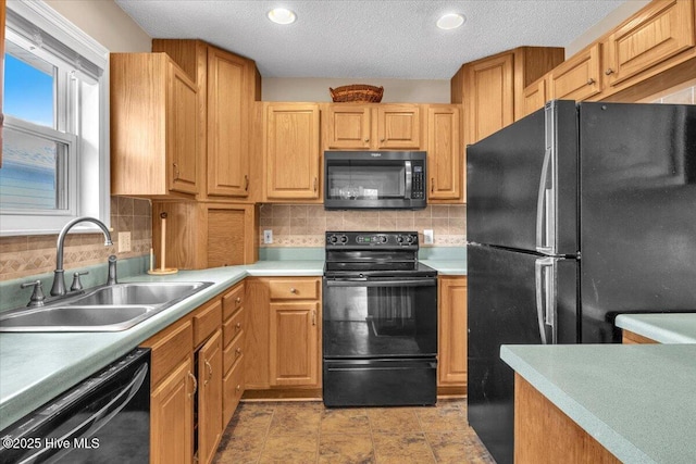 734 Sloop Pointe Ln, Kure Beach, NC 28449 - kitchen with black appliances, a sink, tasteful backsplash, light countertops, and a textured ceiling
