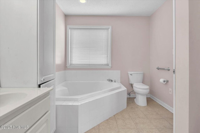 734 Sloop Pointe Ln, Kure Beach, NC 28449 - bathroom featuring toilet, a garden tub, vanity, tile patterned floors, and a textured ceiling