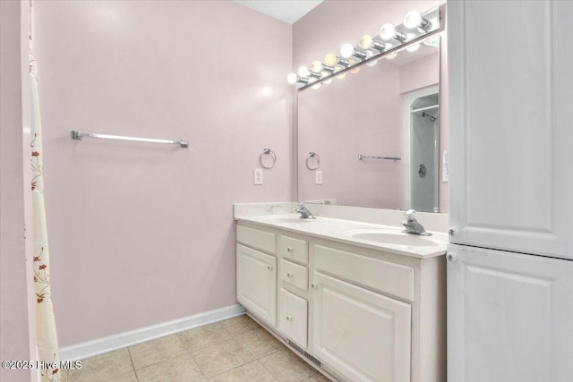 734 Sloop Pointe Ln, Kure Beach, NC 28449 - full bathroom featuring baseboards, double vanity, and tile patterned flooring