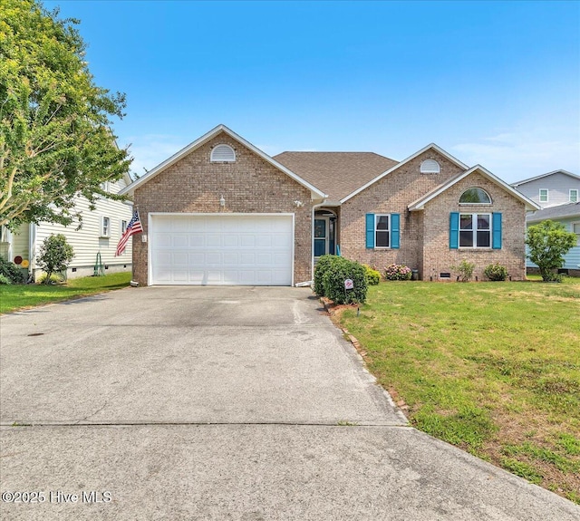 734 Sloop Pointe Ln, Kure Beach, NC 28449 - view of front facade featuring brick siding, asphalt driveway, a front yard, and an attached garage