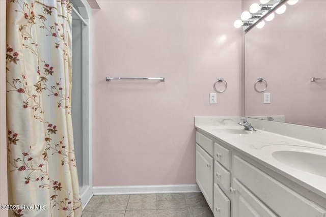 734 Sloop Pointe Ln, Kure Beach, NC 28449 - full bathroom featuring double vanity, baseboards, curtained shower, and tile patterned flooring
