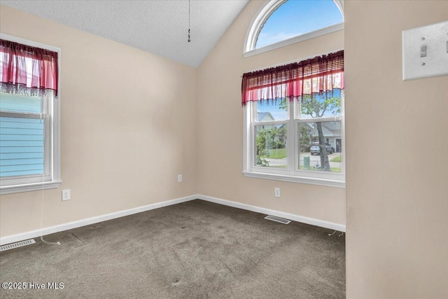 734 Sloop Pointe Ln, Kure Beach, NC 28449 - carpeted empty room featuring vaulted ceiling, baseboards, and a textured ceiling