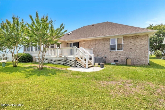 734 Sloop Pointe Ln, Kure Beach, NC 28449 - back of property featuring cooling unit, a deck, a yard, a shingled roof, and brick siding