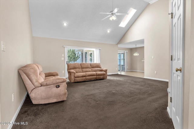 734 Sloop Pointe Ln, Kure Beach, NC 28449 - living area featuring a skylight, carpet floors, baseboards, high vaulted ceiling, and ceiling fan