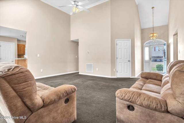 734 Sloop Pointe Ln, Kure Beach, NC 28449 - living area featuring a towering ceiling, dark colored carpet, baseboards, a ceiling fan, and a chandelier