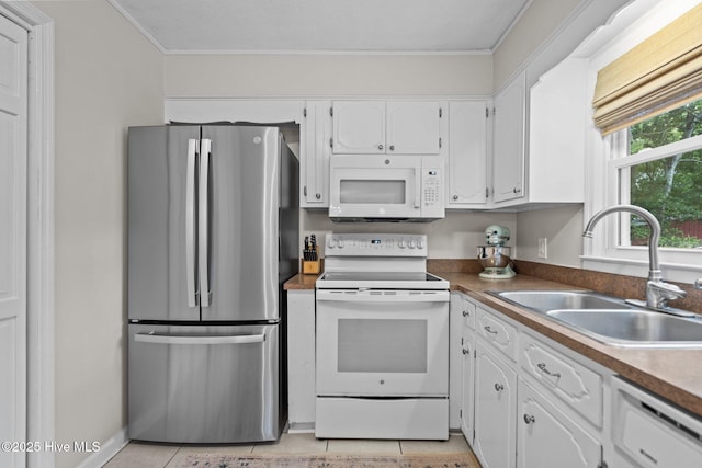 114 Mohican Trl, Wilmington, NC 28409 - kitchen with white appliances, a sink, white cabinetry, crown molding, and light tile patterned flooring