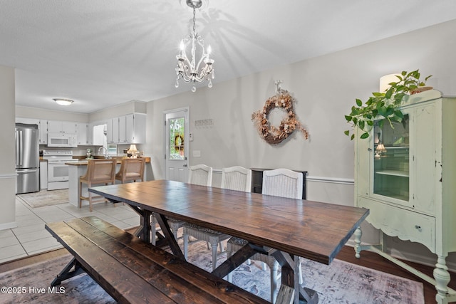 114 Mohican Trl, Wilmington, NC 28409 - dining room with a chandelier and light tile patterned floors