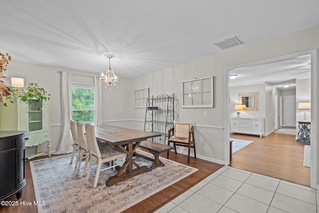 114 Mohican Trl, Wilmington, NC 28409 - dining space featuring a chandelier, light wood-style floors, and baseboards