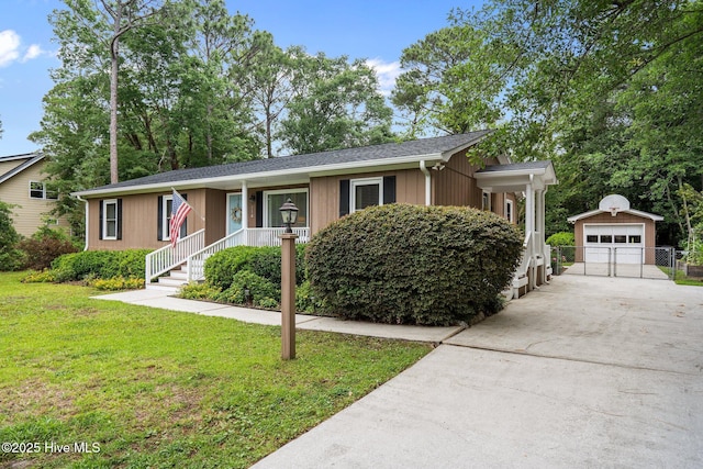 114 Mohican Trl, Wilmington, NC 28409 - single story home featuring an outdoor structure, concrete driveway, a front lawn, and a detached garage