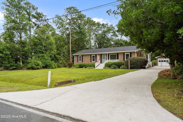 114 Mohican Trl, Wilmington, NC 28409 - ranch-style house with an outdoor structure, a front yard, a garage, and driveway