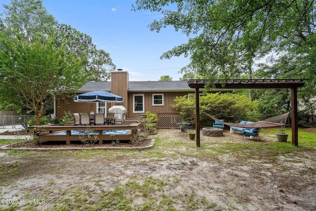 114 Mohican Trl, Wilmington, NC 28409 - back of house with a wooden deck, a chimney, outdoor dining area, and a pergola