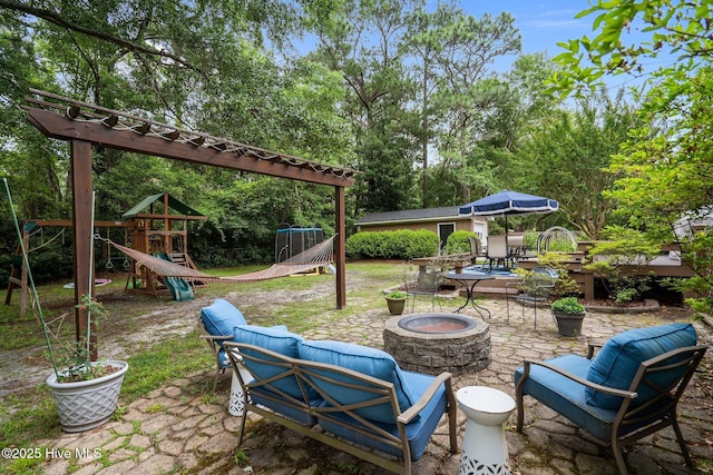 114 Mohican Trl, Wilmington, NC 28409 - view of patio featuring an outdoor fire pit, a playground, and view of scattered trees