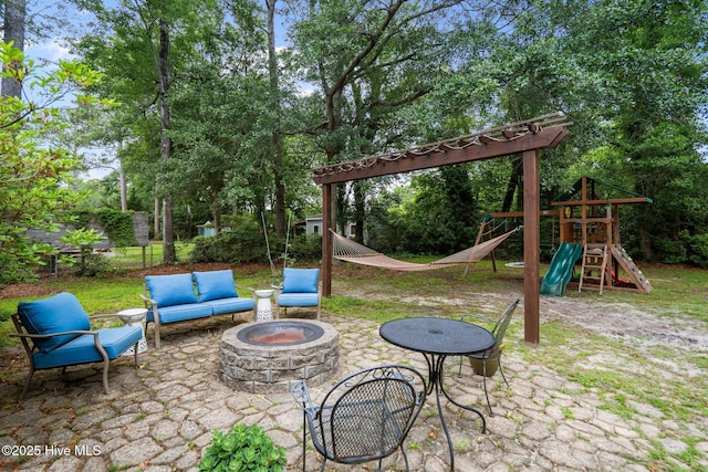 114 Mohican Trl, Wilmington, NC 28409 - view of patio / terrace featuring a fire pit, a playground, and view of wooded area