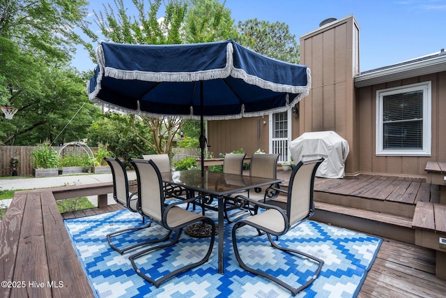 114 Mohican Trl, Wilmington, NC 28409 - wooden deck with outdoor dining space, grilling area, and a patio
