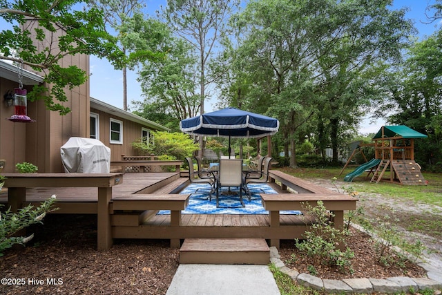 114 Mohican Trl, Wilmington, NC 28409 - wooden deck with outdoor dining space, area for grilling, and a playground
