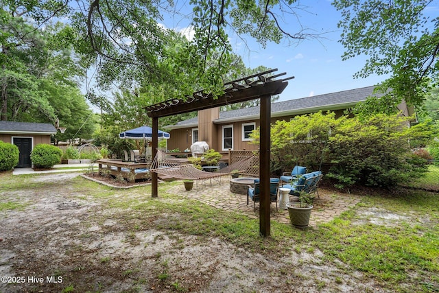 114 Mohican Trl, Wilmington, NC 28409 - view of yard with an outdoor fire pit, a pergola, a patio area, and a deck