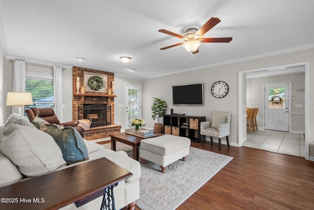 114 Mohican Trl, Wilmington, NC 28409 - living area with a ceiling fan, plenty of natural light, wood finished floors, a fireplace, and crown molding