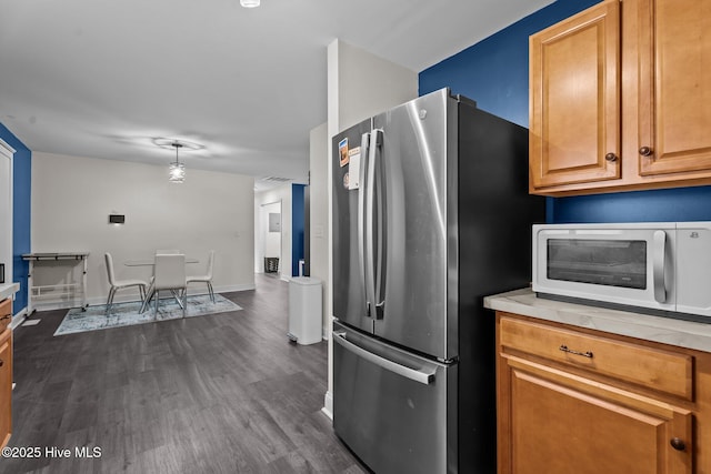 120 Ruby Rd, Goldsboro, NC 27534 - kitchen with freestanding refrigerator, white microwave, dark wood finished floors, light countertops, and brown cabinets