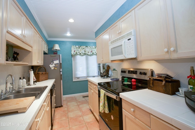 190 Palmetto Rd Unit 20, Pinehurst, NC 28374 - kitchen with stainless steel electric range, white microwave, a sink, tile countertops, and dishwashing machine