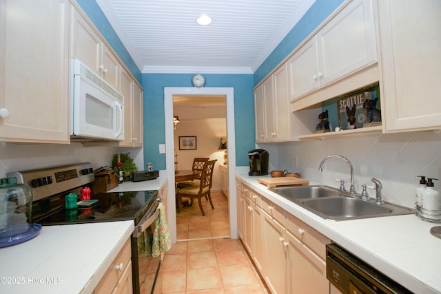 190 Palmetto Rd Unit 20, Pinehurst, NC 28374 - kitchen with white microwave, stainless steel electric range oven, tile countertops, a sink, and crown molding