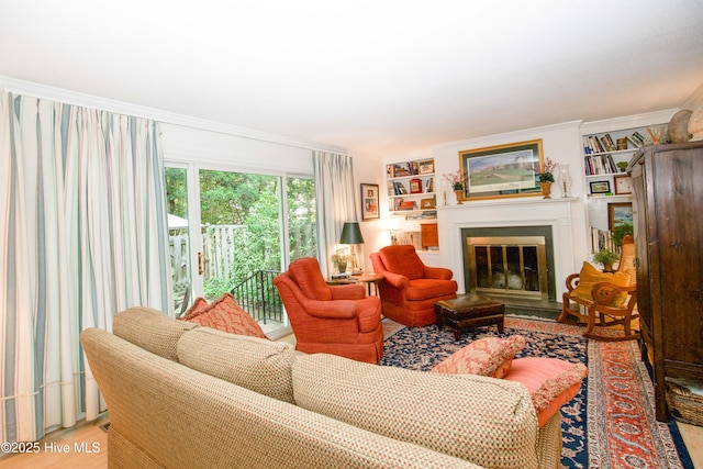190 Palmetto Rd Unit 20, Pinehurst, NC 28374 - living area featuring a fireplace with flush hearth, ornamental molding, light wood-style flooring, and built in features