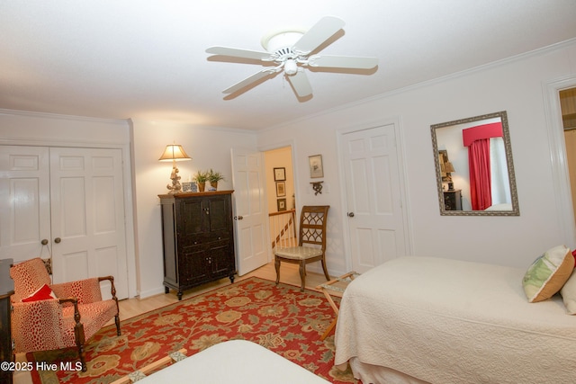 190 Palmetto Rd Unit 20, Pinehurst, NC 28374 - bedroom with light wood-style flooring, crown molding, a ceiling fan, and a closet