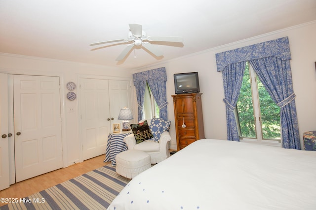 190 Palmetto Rd Unit 20, Pinehurst, NC 28374 - bedroom with multiple closets, crown molding, light wood-style flooring, and a ceiling fan