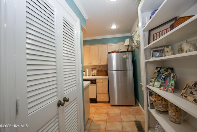 190 Palmetto Rd Unit 20, Pinehurst, NC 28374 - kitchen featuring freestanding refrigerator, light brown cabinets, light tile patterned floors, ornamental molding, and light countertops