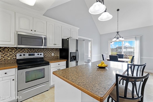 202 Brookside Way, Pikeville, NC 27863 - kitchen featuring stainless steel appliances, dark countertops, a chandelier, white cabinetry, and decorative backsplash
