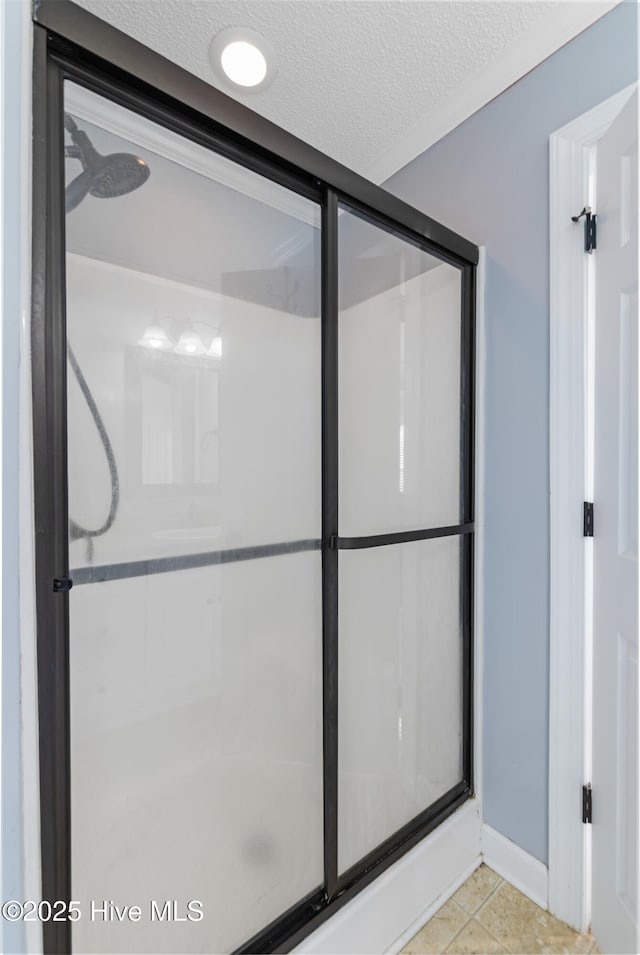 202 Brookside Way, Pikeville, NC 27863 - full bathroom featuring a shower stall, baseboards, a textured ceiling, and tile patterned floors