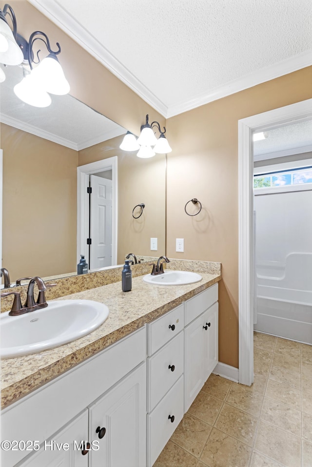202 Brookside Way, Pikeville, NC 27863 - bathroom with double vanity, ornamental molding, a textured ceiling, a bathtub, and tile patterned flooring