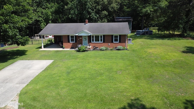 127 Deans Ln, Goldsboro, NC 27530 - ranch-style home with brick siding, a porch, a front lawn, and a chimney