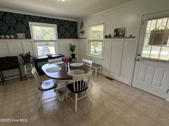 127 Deans Ln, Goldsboro, NC 27530 - dining area featuring a decorative wall, ornamental molding, and a wainscoted wall