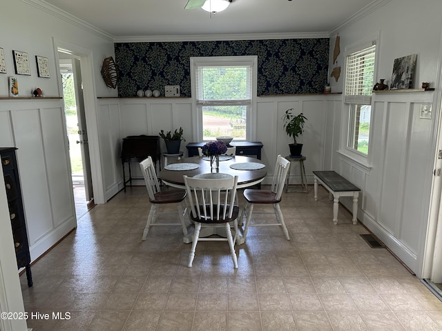 127 Deans Ln, Goldsboro, NC 27530 - dining area with a decorative wall, ornamental molding, and a wainscoted wall