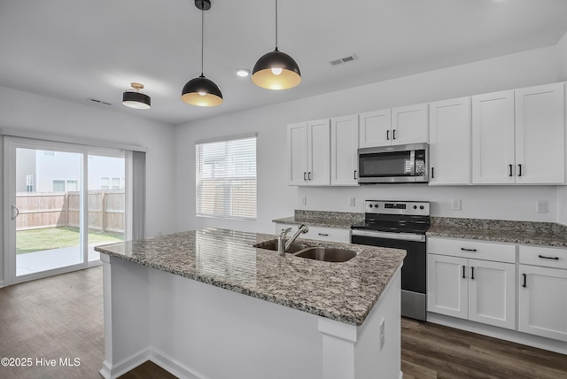 1617 Stanley St, Wilmington, NC 28401 - kitchen featuring appliances with stainless steel finishes, a sink, dark wood-style flooring, and dark stone counters