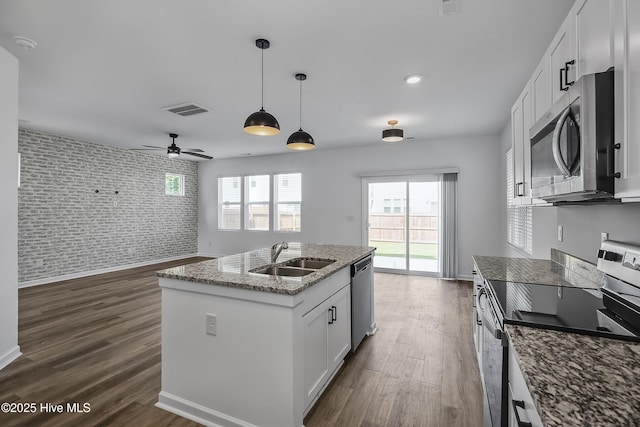 1617 Stanley St, Wilmington, NC 28401 - kitchen with appliances with stainless steel finishes, a sink, brick wall, ceiling fan, and an accent wall
