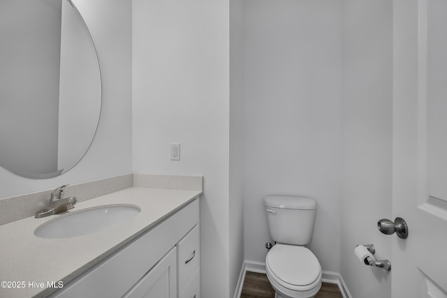 1617 Stanley St, Wilmington, NC 28401 - bathroom with toilet, vanity, wood finished floors, and baseboards