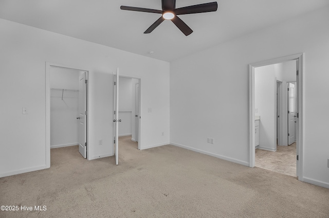 1617 Stanley St, Wilmington, NC 28401 - unfurnished bedroom featuring light carpet, a walk in closet, baseboards, ensuite bath, and a ceiling fan