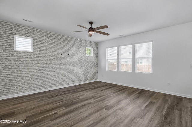 1617 Stanley St, Wilmington, NC 28401 - spare room with a ceiling fan, dark wood-style floors, baseboards, and brick wall