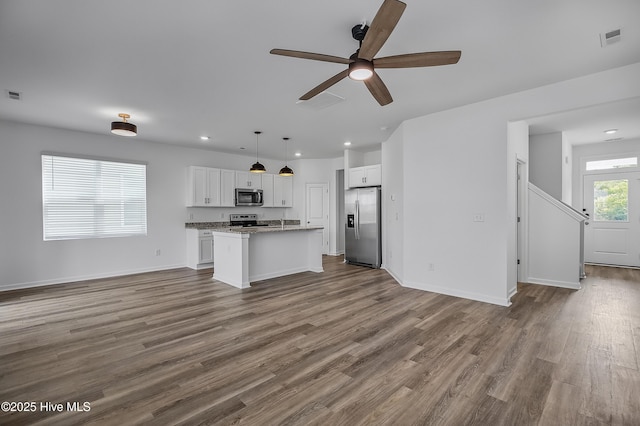 1617 Stanley St, Wilmington, NC 28401 - unfurnished living room featuring ceiling fan, dark wood finished floors, recessed lighting, and baseboards