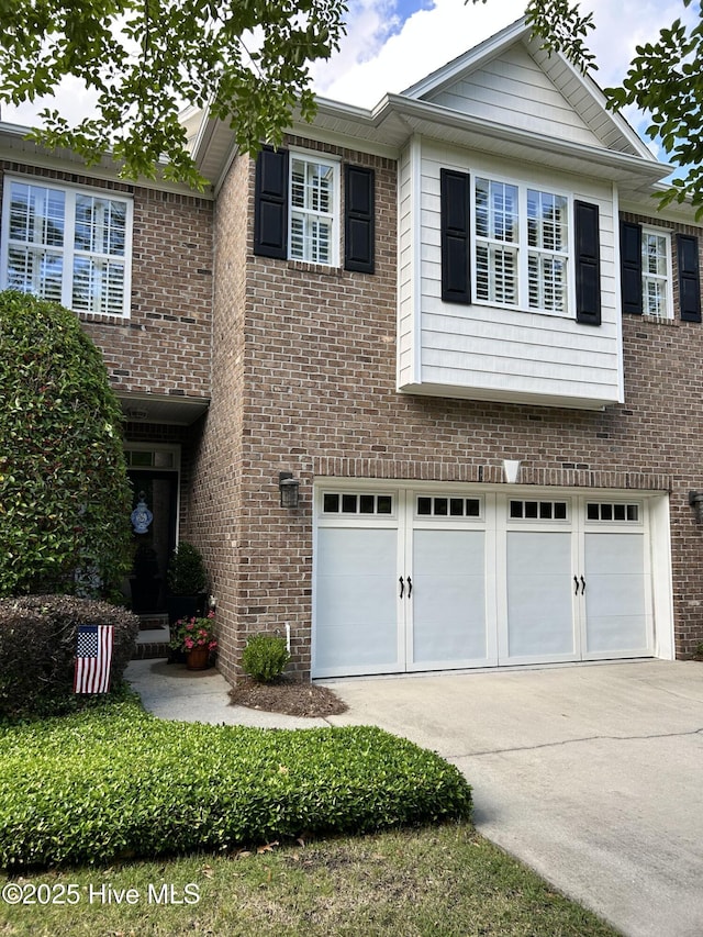 4915 Whitner Dr, Wilmington, NC 28409 - view of front of house featuring concrete driveway, an attached garage, and brick siding