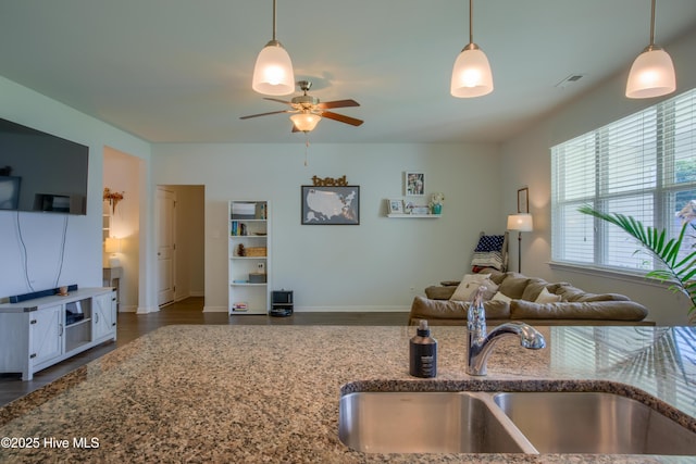 402 Saxby Way, Holly Ridge, NC 28445 - kitchen featuring a sink, stone counters, open floor plan, ceiling fan, and wood finished floors