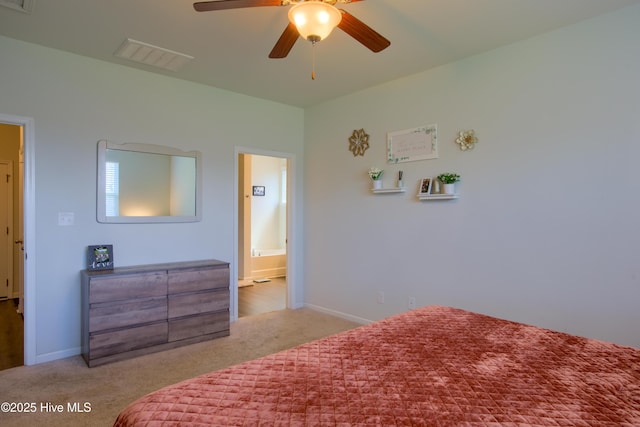 402 Saxby Way, Holly Ridge, NC 28445 - carpeted bedroom with baseboards, ceiling fan, and ensuite bathroom