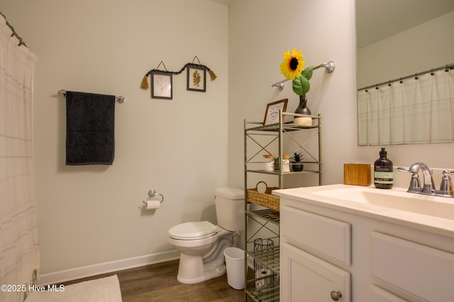 402 Saxby Way, Holly Ridge, NC 28445 - bathroom with wood finished floors, toilet, vanity, and baseboards
