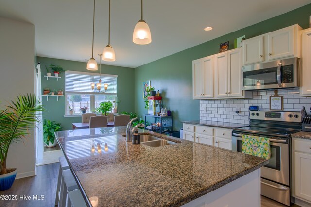 402 Saxby Way, Holly Ridge, NC 28445 - kitchen with appliances with stainless steel finishes, a sink, wood finished floors, and white cabinetry