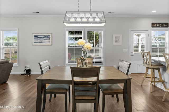 97 Violetear Rdg, Hampstead, NC 28443 - dining area featuring dark wood-type flooring, crown molding, and baseboards
