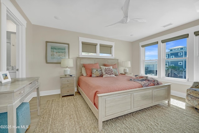 4920 E Beach Dr, Oak Island, NC 28465 - bedroom with baseboards, a ceiling fan, and light wood-type flooring
