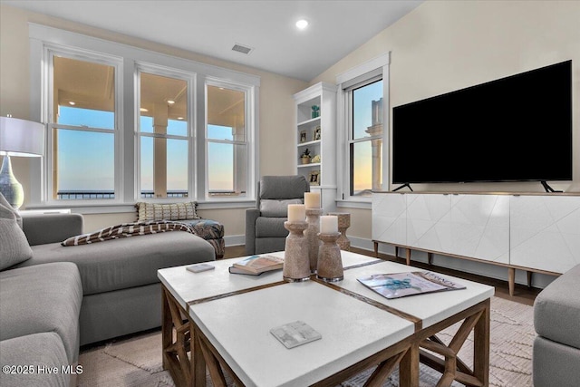 4920 E Beach Dr, Oak Island, NC 28465 - living room featuring healthy amount of natural light and lofted ceiling