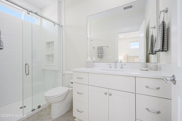 4920 E Beach Dr, Oak Island, NC 28465 - full bath with toilet, vanity, a shower stall, and plenty of natural light