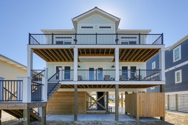 4920 E Beach Dr, Oak Island, NC 28465 - view of front of home with stairs, a deck, and a carport
